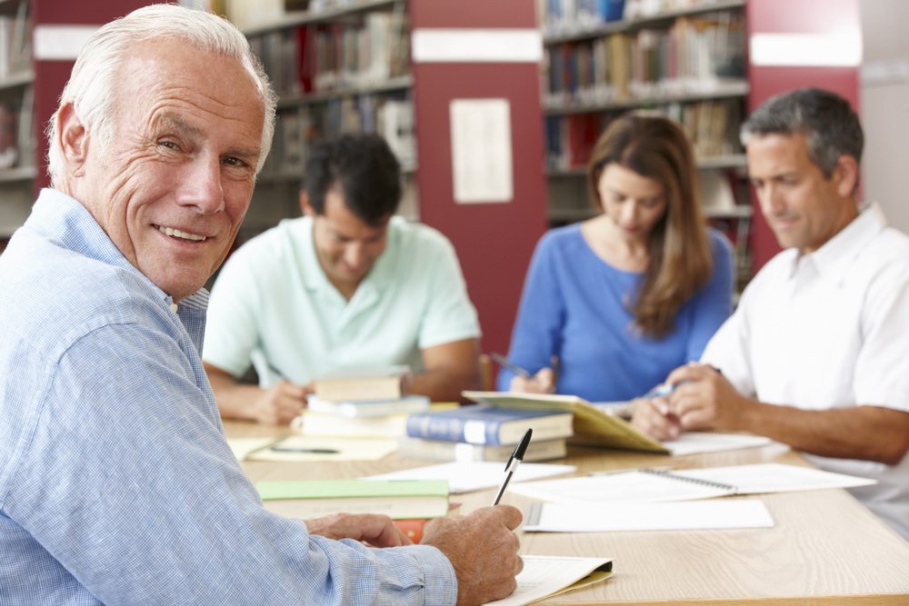 mature man writing with students.jpg